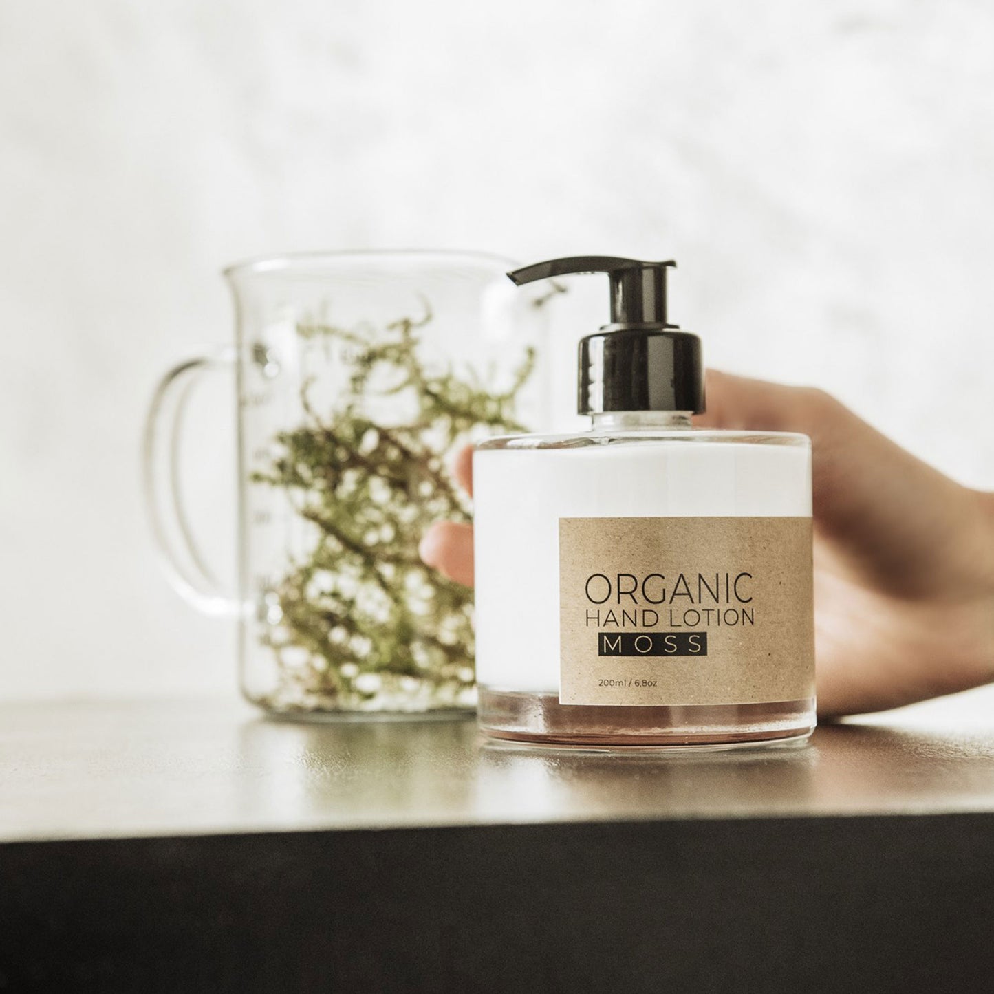 Moss organic hand lotion in glass bottle