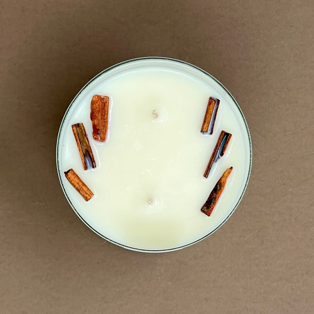 Cinnamon candle in a glass votive with 2 wicks