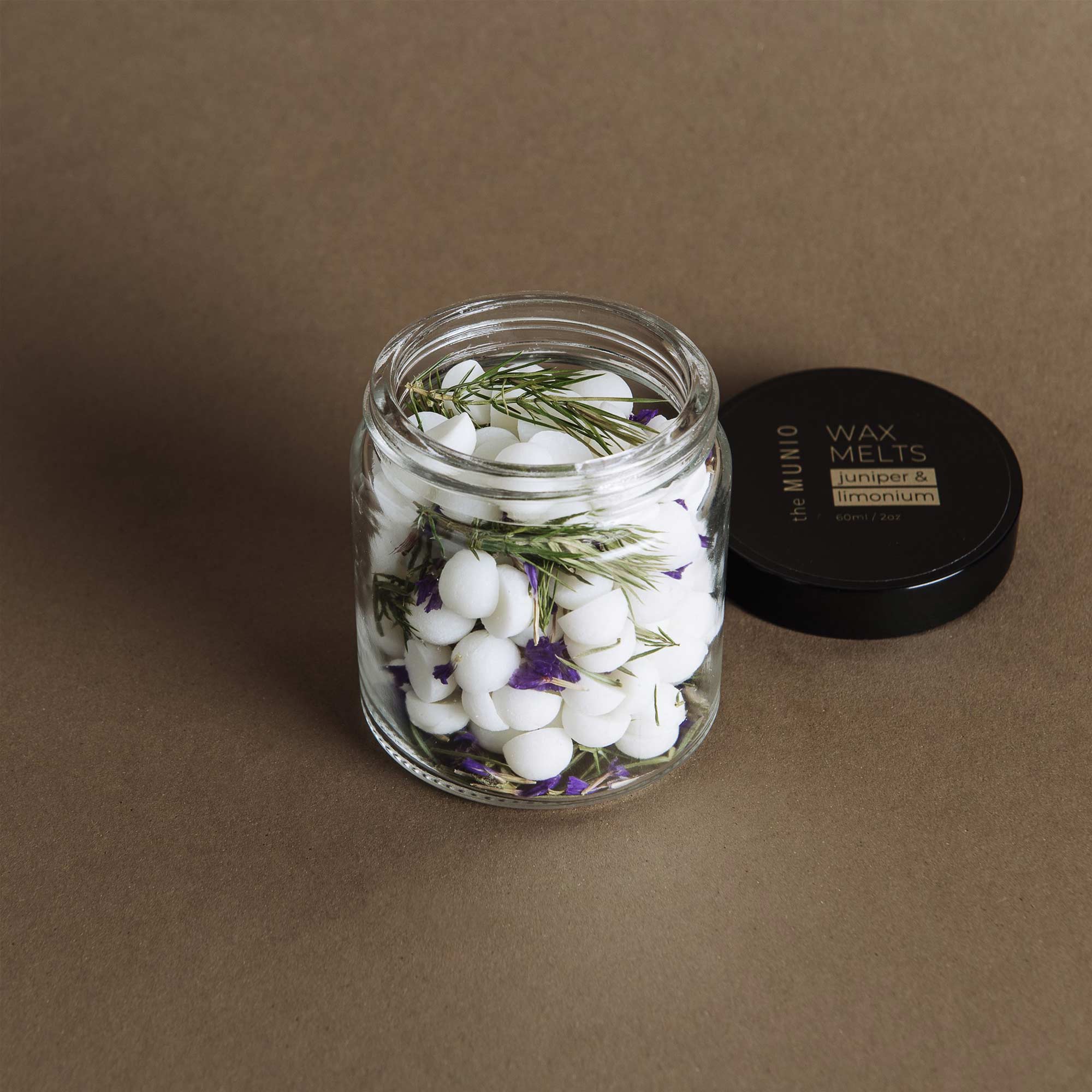 Juniper and limonium mini soy wax melts in a glass votive