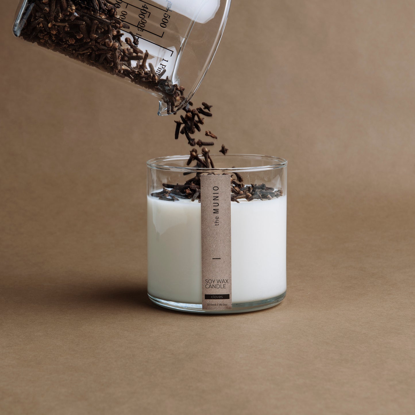 Cloves & orange candle in a glass votive