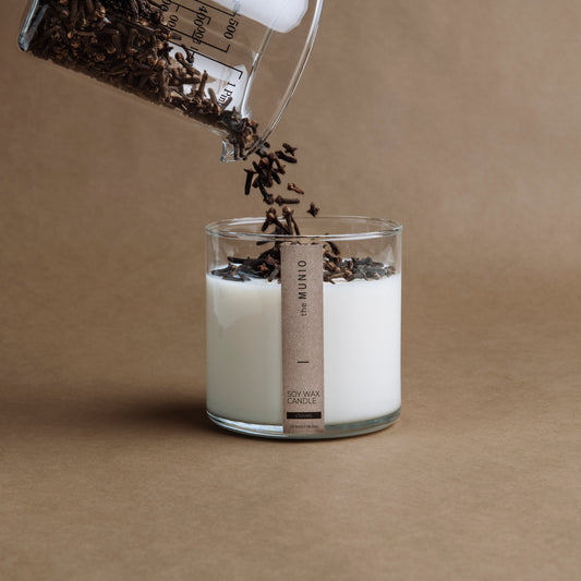 Cloves & orange candle in a glass votive